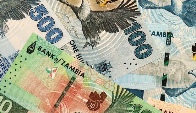 Zambian kwacha money bills in pile on table. Zambia ZMW currency cash close up