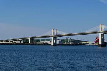 Obraz premium Beautiful coastal view of a large modern cable stayed bridge over the calm blue sea under a clear sky, Fukushima Japan.