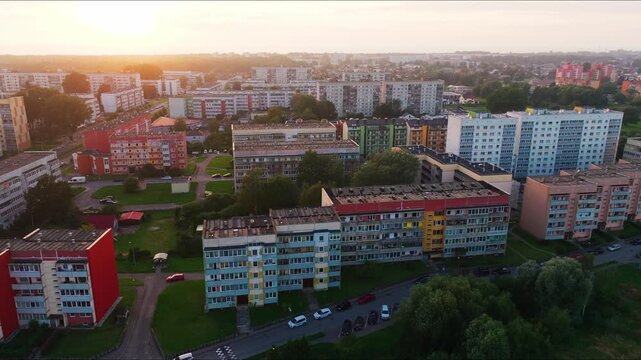 Drone slides right revealing Liepaja lakefront and renovated Soviet era housing