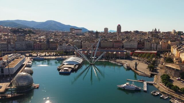 Aerial view of Genoa harbor waterfront with marina, modern piers, and city backdrop