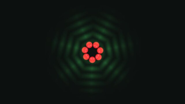 Shapes in red and green form a pattern against a dark background. The colors create visual interest with a symmetrical layout that catches the eye