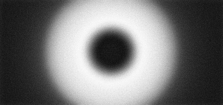 Abstract black white grainy background central dark circular hole blurry white ring