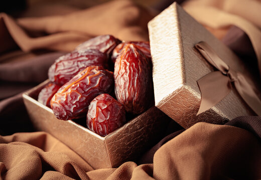 Dates fruits in golden gift box.