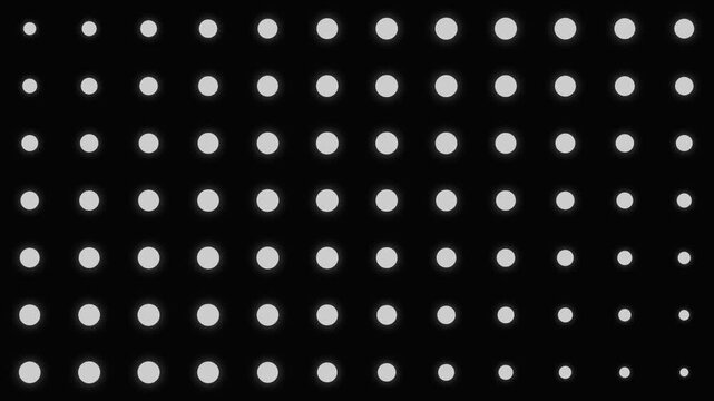 A grid of white circles diminishing in size on a deep black background