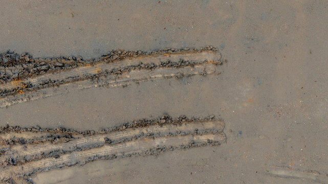 Aerial view wheel tire track on mud, Tire mark imprints on mud vehicles tires footprints transport ground trace or marks textures, wheel treads, Mud terrain.