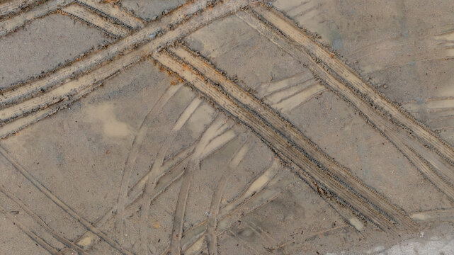 Aerial view wheel tire track on mud, Tire mark imprints on mud vehicles tires footprints transport ground trace or marks textures, wheel treads, Mud terrain.