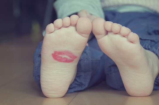 Close-up of a Lipstick kiss on the sole of a young girl's foot