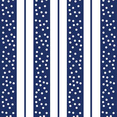 Fototapeta premium Seamless geometric pattern featuring vertical navy blue stripes and scattered white polka dots ideal for nautical summer fashion winter snow wrapping paper and classic kids interior decor