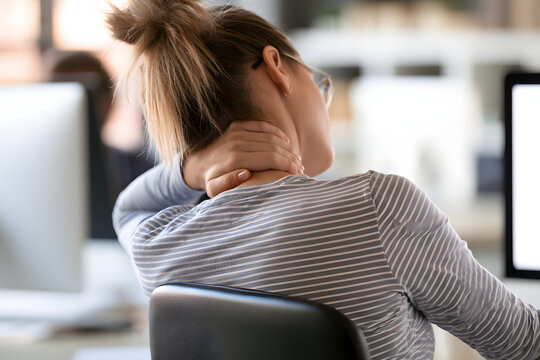 Woman Suffering from Neck and Shoulder Pain During Desk Work