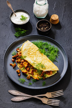 Egg omelet with fried wild chanterelles and dill