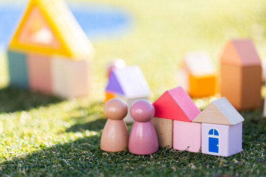 Couple with home concept depicted in childs toy blocks on fake grass