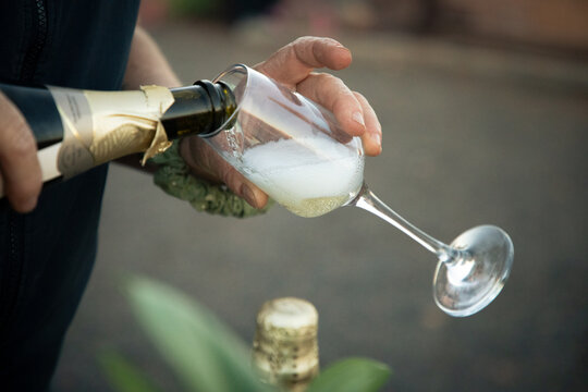 Woman pouring a glass of sparkling wine