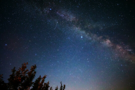 Summer Milky Way stars and landscape scenery silhouettes.