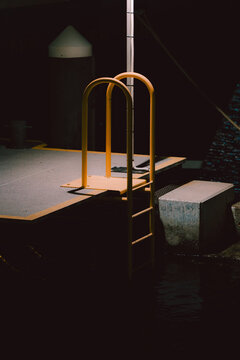 Yellow metal handrail at the dockside