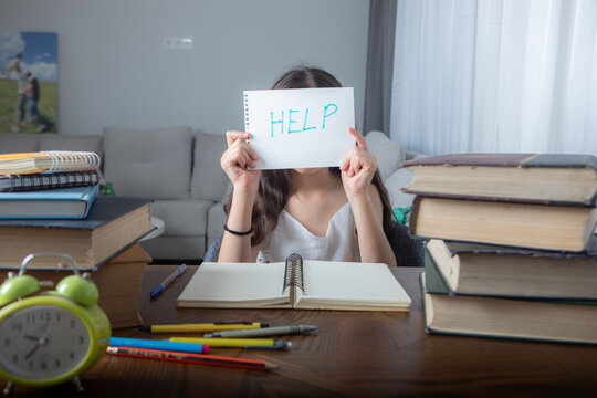 Young girl holds paper written help. Student needs support