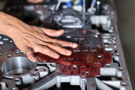 Mechanic checking separator plate on automatic transmission valve body