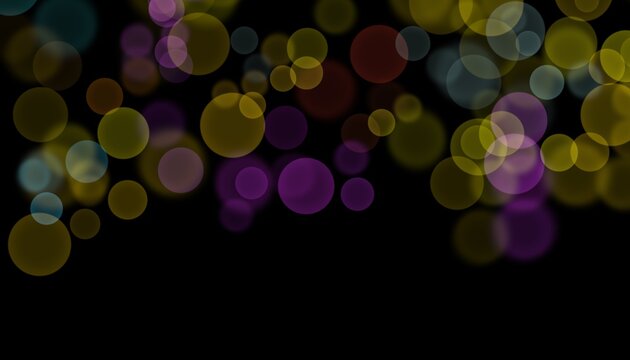 Abstract colorful bokeh light circles floating and glowing against a solid dark black background