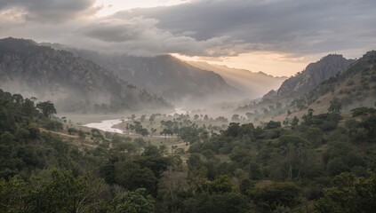 Obraz premium Mist Covered Valley with River and Mountains at Sunrise