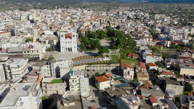 Drone panorama over Pyrgos city, Ilia, Greece. Church of Saint Nicolas, Sakis Karagiorgas Square. Eparxeion and Tomb of Unknown Soldier visible