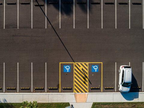 Overhead aerial of carpark with accessible disabled parking spaces by ramp