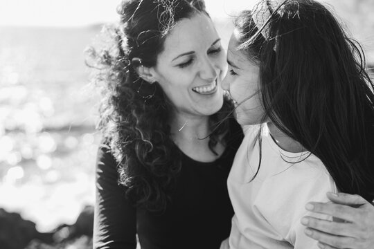 Happy latin mother and daughter having fun outdoor - Love, family and mum day concept - Main focus on kid eye - Black and white film camera editing - UGC content