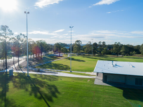 Alroy oval sports ground with new clubhouse building between fields