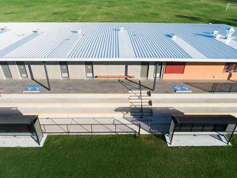 Alroy oval sports ground with new clubhouse building in green playing field