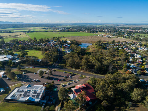 Aerial view over Singleton Heights towards school and club building with carpark