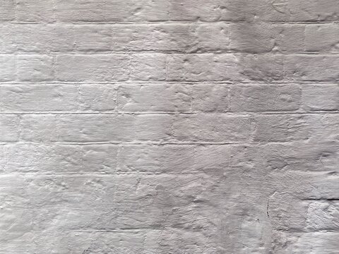 White plaster wall texture background with natural weathered surface for design, architecture and copy space.