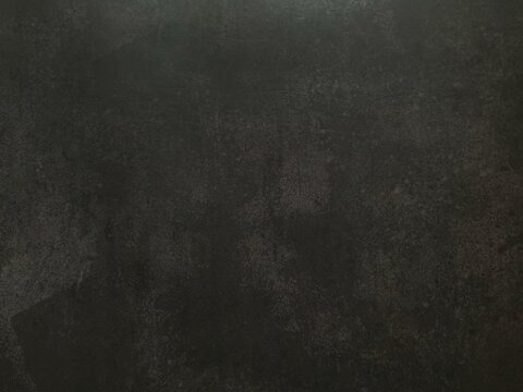 Dark black textured background with subtle grunge surface for modern design and copy space.