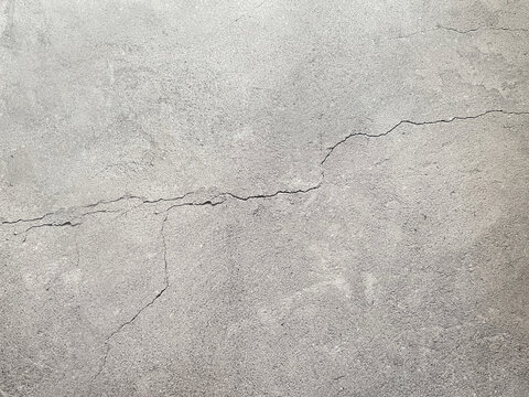 Cracked concrete surface texture background representing aging, damage and industrial design.