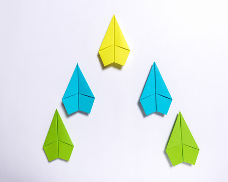 Yellow Paper Airplane Leading V Formation on White Background