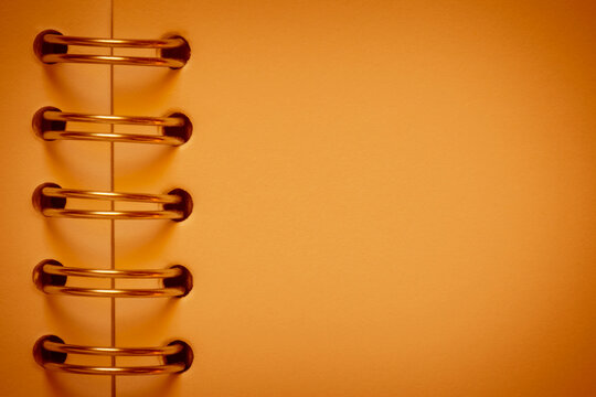 vintage backdrop: close up of blank pumpkin color page of aged sketchbook