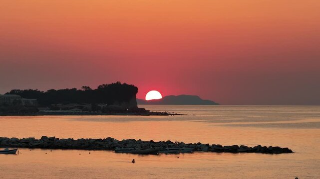 Beautiful Red Sunset over the Ionian Sea with Silhouette Cliff and Distant Islands, Roda Beach, North Corfu, Greek Island, Greece - 4K Video Shot
