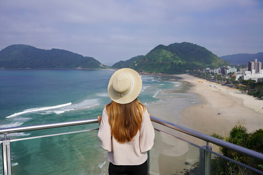 Young woman enjoying view from lookout of Brazilian beach in Guaruja, Sao Paulo State, Brazil
