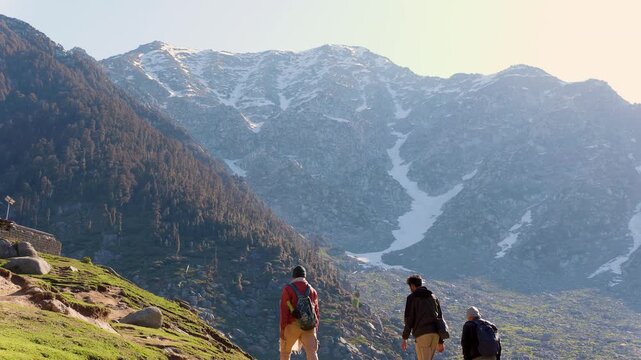 Hikers trekking mountains. People exploring nature, Kareri Lake, Dharamshala, Himachal Pradesh.
