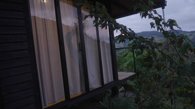 young man needs a new day to take the light into his home and shelter the curtains in his countryside home