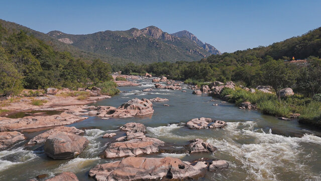 Drone photograph of Crocodile River in Mpumalanga, South Africa, early morning July 202
6, showing flowing water and stones in natural landscape.