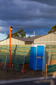 surveillance security camera by stockpiles at worksite by portaloo toilet