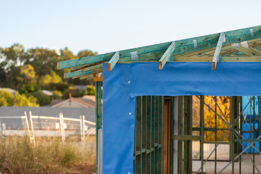 new house build under construction home made of wooden frame with blue cladding