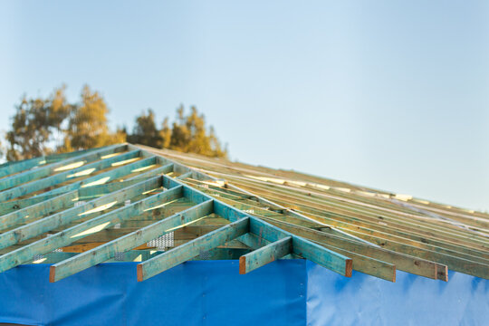 wooden roof structure of house under construction during housing crisis