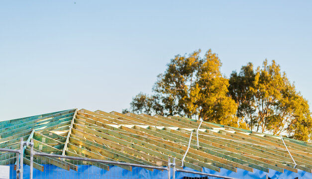 wooden roof structure of house under construction during housing crisis