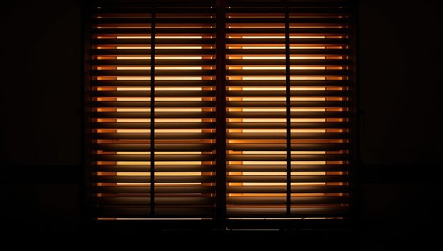 Illuminated Wooden Blinds Casting Shadows in a Dark Room