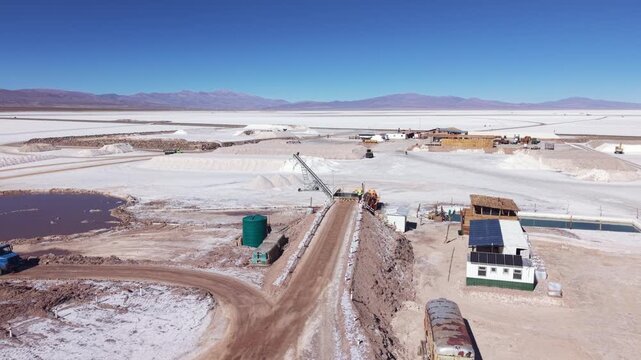 Drone aerial video of salt extraction facility, service road and processing ponds in Salinas Grandes, Argentina.