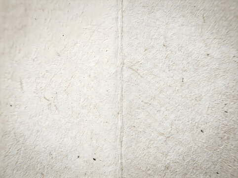 Closeup of a rough textured surface with visible seam and imperfections