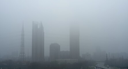 Fototapeta premium Foggy Cityscape with Skyscrapers - Urban Skyline, Soft Focus, Mysterious Atmosphere