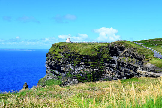 The famous Cliffs of Moher in Ireland. The striking tower on the rocky outcrop is O'Brien's Tower, built in 1835. The cliffs are a well-known UNESCO World Heritage Site.