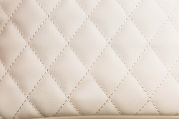 Obraz premium Close up view of leather textured white background showing diamond pattern with stitching and soft material