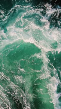 Blue waves of water of the river and the sea meet each other during high tide and low tide.