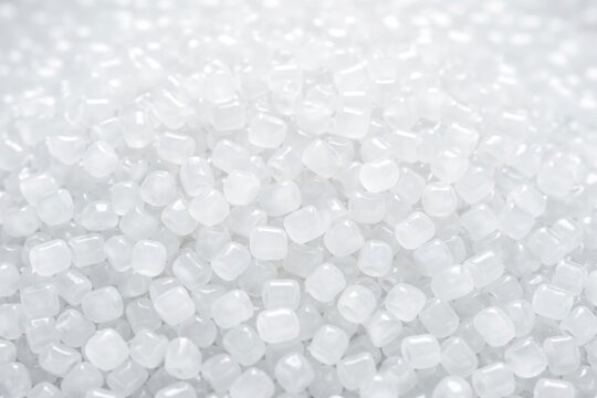 Translucent Plastic Pellets Piled Together on a Light Background